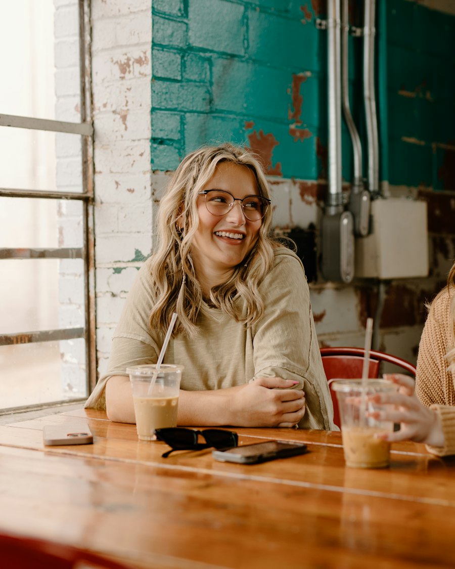 Two women talking over coffee at a wooden table